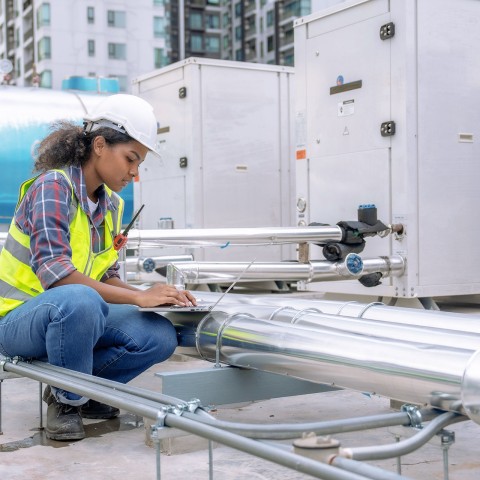 woman examining an air conditioning system