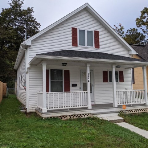 image of white home with red shutters 