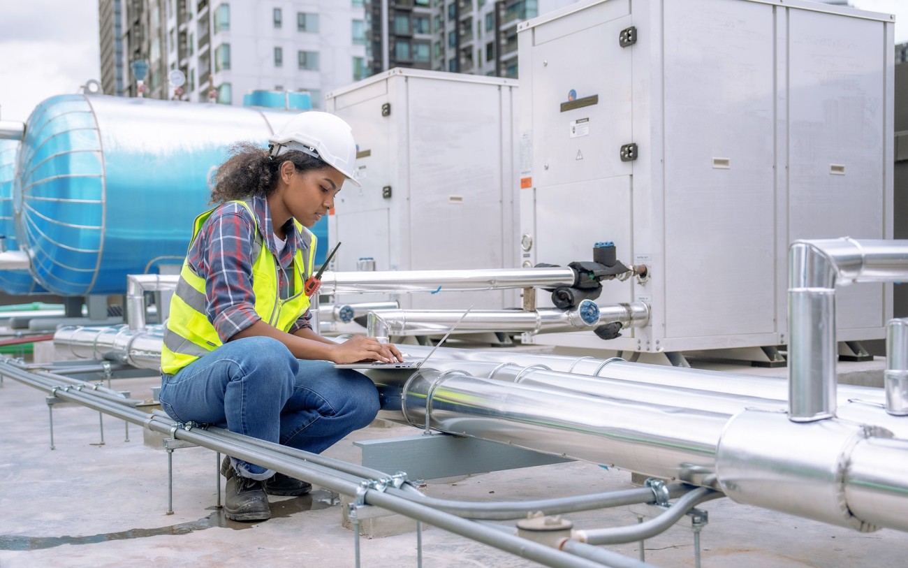 woman examining an air conditioning system