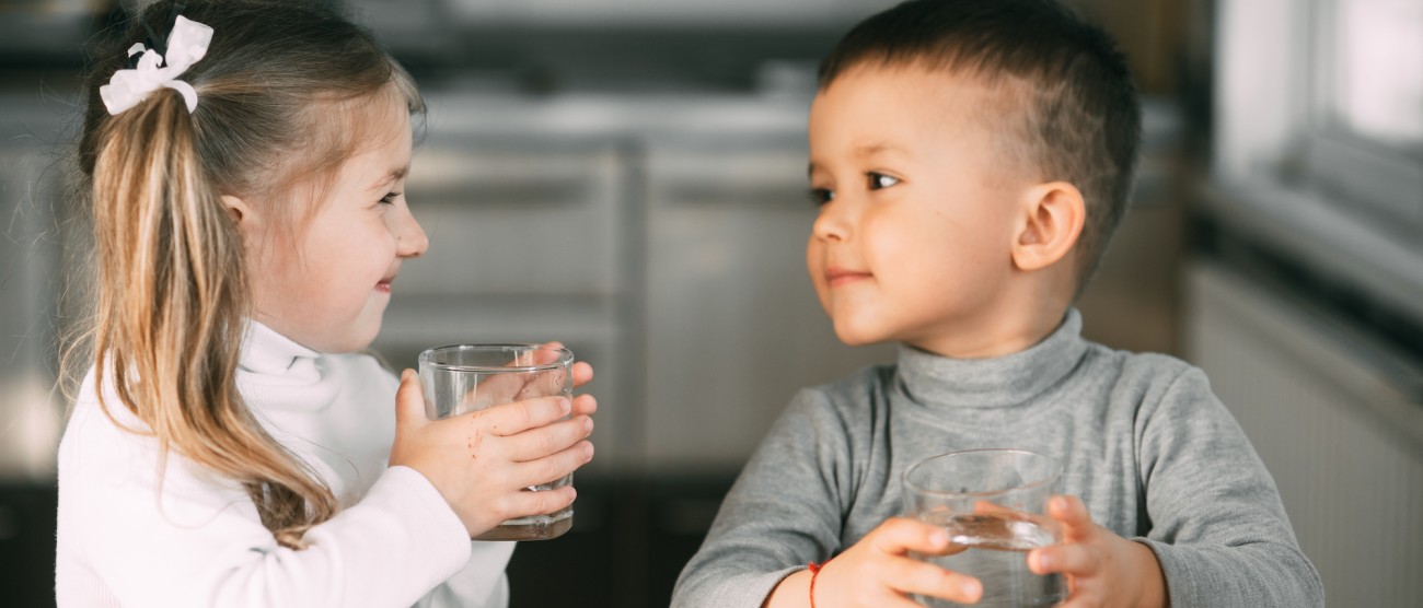 smiling children drinking water. 