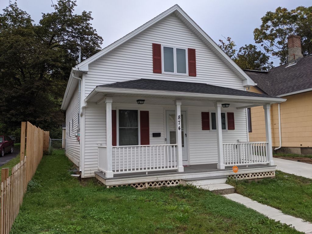 image of white home with red shutters 
